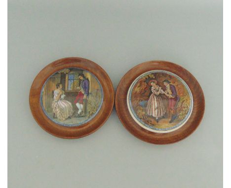 Two Staffordshire Prattware polychrome pot lids, mounted in light wooden frames., titled 'First Appeal' and 'Second Appeal', 