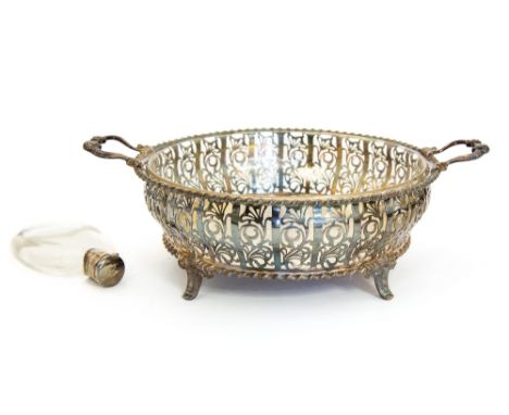 A George V silver reticulated basket, circular dish form with panels of pierced foliate decoration, gadrooned rim and cast ac