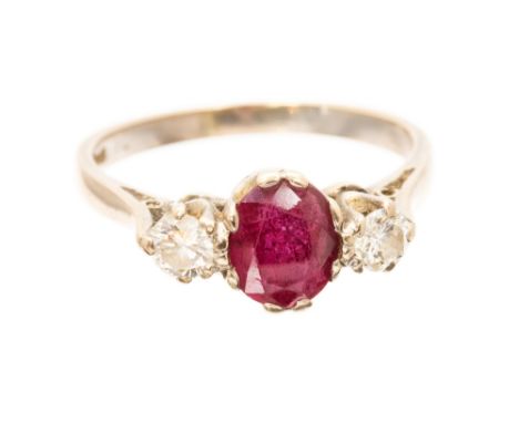 A ruby and diamond three stone 18ct white gold ring, ruby approx 1.25 carats, two round brilliant cut diamonds weighing a tot