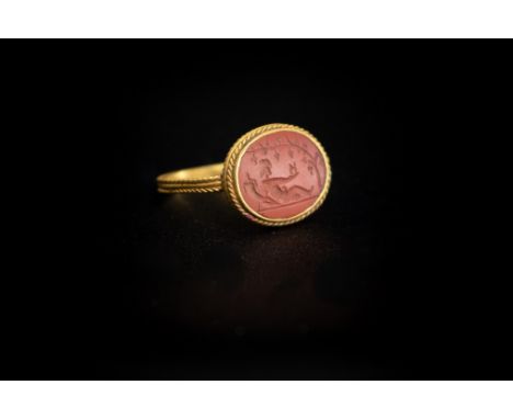 Roman (1st-4th century AD) Gold ring with band consisting of four plaited wires; oval bezel with twisted rope border set with