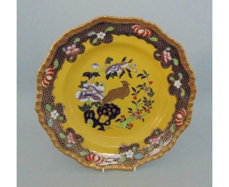 A Masons ironstone plate, yellow ground and cobalt blue and gilt border with scattered flowers, the centre with Oriental flow