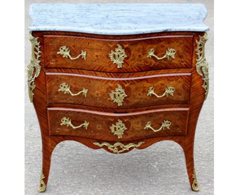A 19th Century Louis XV style 'Bombe' marble topped commode, the white marble top with moulded edges, the chest with three sh