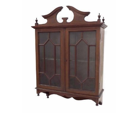 Edwardian mahogany inlaid wall display cabinet with a broken swan neck pediment over astragal glazed doors enclosing a single