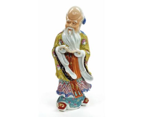 Chinese porcelain figure of Hotei, modelled standing wearing a floral robe and holding a scroll, impressed mark, 13" high