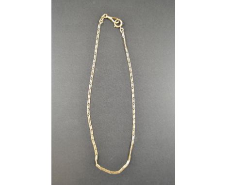 A gold (tests as 14k) flat link watch chain - L42cm, approx weight 14g  CONDITION REPORT: Good condition.