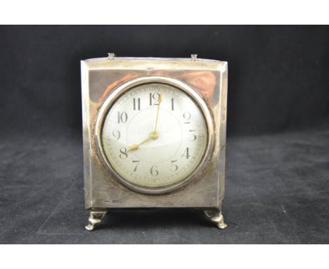 A silver mounted, leather covered mantel clock, Chester 1915, scroll feet, platform lever escapement and convex white enamel 