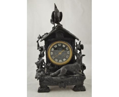A 19th century cast iron mantle clock depicting a fox scaring a cockerel, two train brass drum movement, enamel Roman numeral