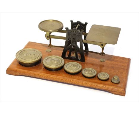 A set of brass and iron postal scales, by Setten &amp; Durward, early 20th century, in the Art Nouveau taste, the oak base su