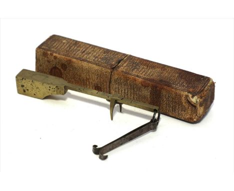 A brass shelf edge bismar, c.1870, measuring ¼oz to 2oz, within a card case, 8.5cm long