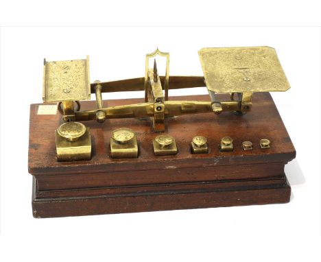 A set of brass roberval postal scales, by Joseph &amp; Edmund Ratcliff, mid-19th century, the mahogany base with enclosed sta