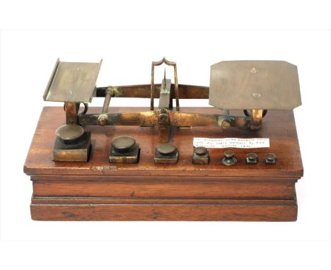 A set of brass roberval postal scales, by Joseph &amp; Edmund Ratcliff, mid-19th century, the mahogany body with encased stay