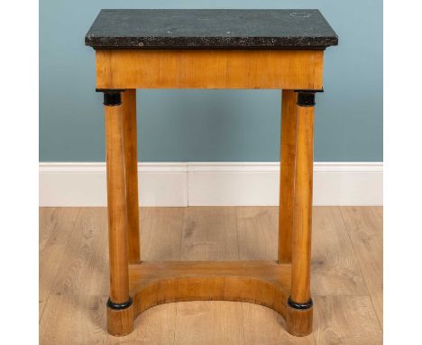 A Biedermeier console table with marble top, late 19th century, fruitwood with ebonised head and base of column supports and 