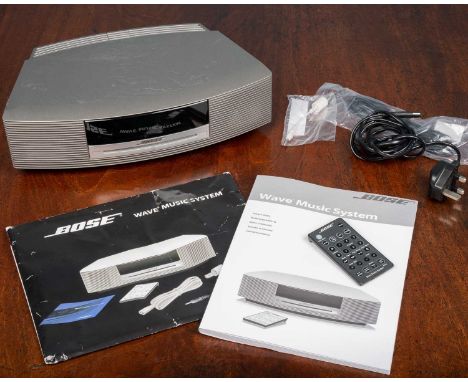 A Bose Wave Music System together with wires, control and manualAs found.