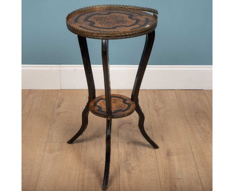 A walnut veneer top tripod wine table, with veneered designs to the surface and smaller bottom shelf, supported by three ebon