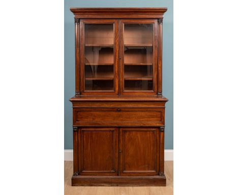 A large 19th century secretaire, mahogany, bottom cabinet opens to reveal a singular shelf and upper cabinet glass doors open