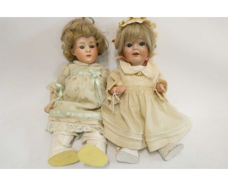 Two Heubach socket head dolls, one 11 1/2" 6970 doll with sleeping eyes, closed mouth and fixed wrists, and a 12" 10557 with 