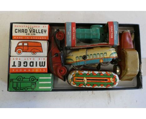 Eight small clockwork vehicles by Chad Valley and others including vans, buses and tractor,some items boxed, fair