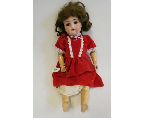 A Kammer &amp; Reinhardt bisque socket head doll, with brown glass sleeping eyes, open mouth, teeth, pierced ears, brown wig,