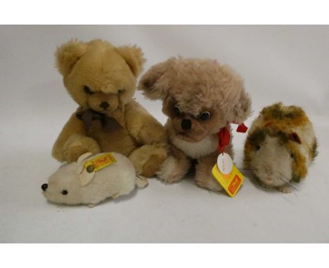 Four Steiff plush toys, comprising a Petsy dog, with googly eyes and white metal ear button, 11" overall, a guinea pig, with 