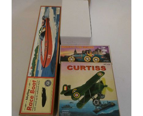 Four late issue tinplate toys comprising of speed boat, Bugatti Racer, Curtiss airplane and Schuco vintage car all items boxe