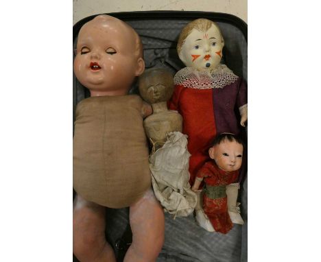 Four collectors dolls, comprising a part Victorian peg doll, a composition Japanese doll, a composition clown doll and a comp