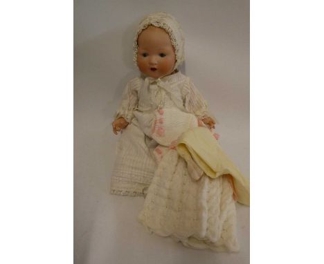 An Armand Marseille bisque socket head baby doll, with blue glass sleeping eyes, open mouth, teeth, moulded hair, bent limb c