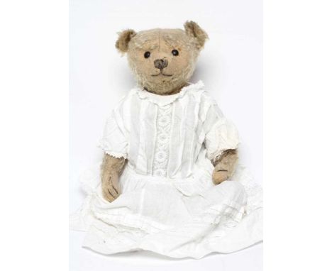 A centre seam early steiff teddy bear, c.1904, with black button eyes, straw filling, sewn nose, light orange plush, felt pad