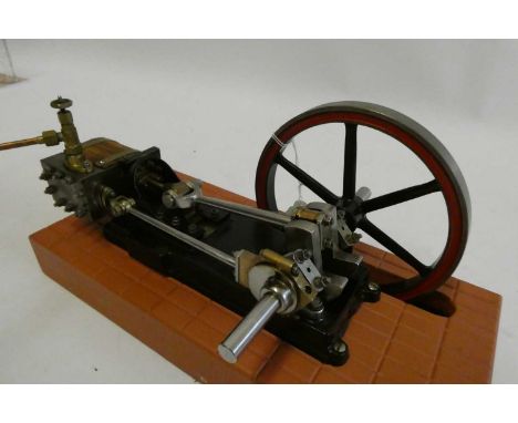 A Reeves Engineering Unicorn horizontal single cylinder non reversing mill engine, mounted on wooden base with carved floor t