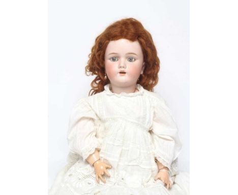 A Handwerck Halbig bisque socket head doll, with blue glass sleeping eyes, open mouth, teeth, pierced ears, brown wig, wood a