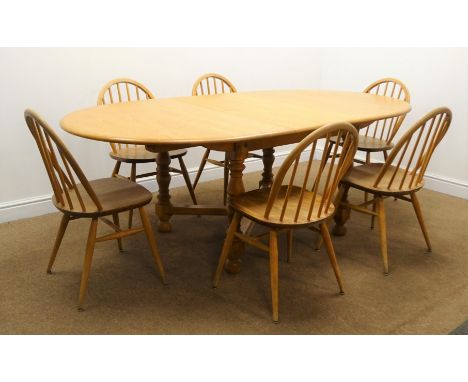 Ercol light elm oval extending dining table, turned supports, 'X' framed stretchers W213cm, H73cm, D108cm) and set six hoop b
