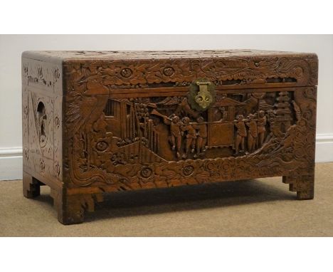 Late 20th century camphor wood blanket box, deep carved with Eastern scenes, hinged lid, shaped bracket supports, W89cm, H49c
