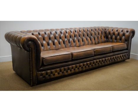 Chesterfield four seat sofa upholstered in deep buttoned brown leather, W245cm