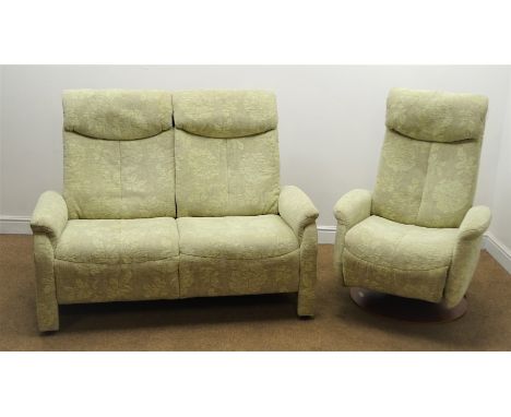 Sitbest Norway electric reclining swivel armchair, upholstered in a floral patterned seafoam green fabric on French cherry wo