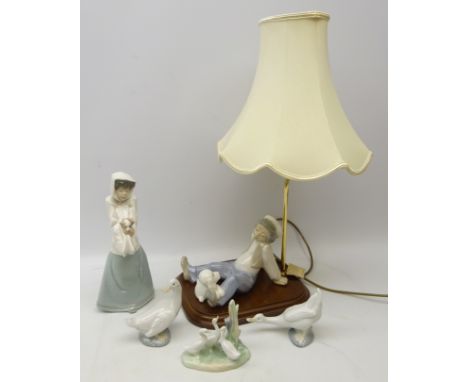 Nao figure of a girl holding puppy no. 1296, three Nao Geese and similar style Spanish lamp modelled as a boy sat with poodle