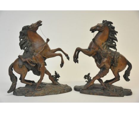 A pair of late 19th century bronze Marley horses with signed bases