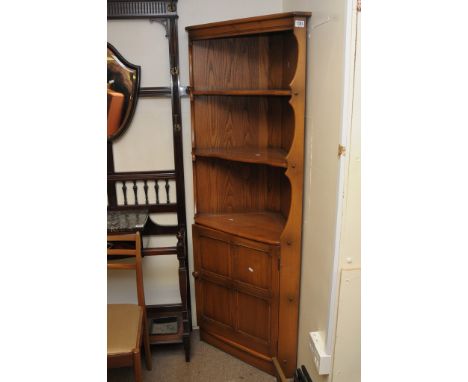 An Ercol light elm corner cabinet