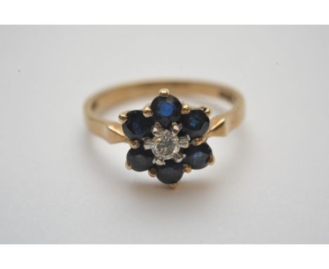 A ladies 9ct gold ring set with a central brilliant cut diamond with sapphire surround