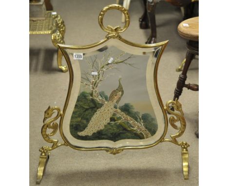 A brass surround mirrored fire screen decorated with a scene of a peacock