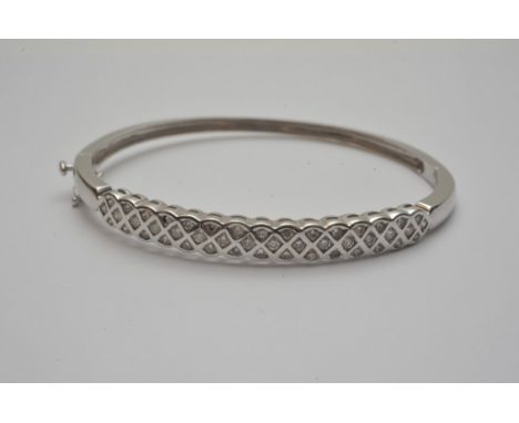 A 9ct white gold diamond set bangle