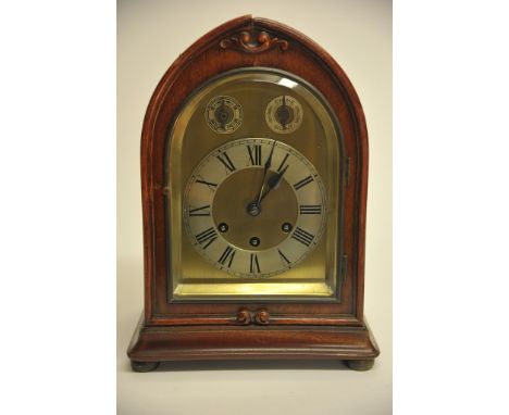 An Edwardian mahogany mantle clock having arch shaped dial with silvered chapter ring