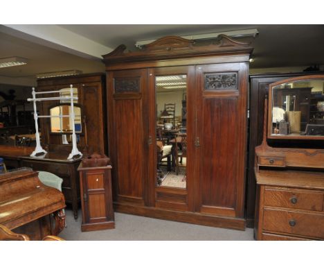 A large walnut three section wardrobe with matching bedside cabinet