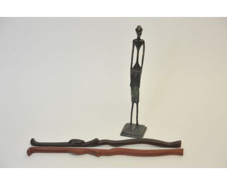 A bronze tribal art figure of highly stylised narrow form and two wooden elongated tribal figures.