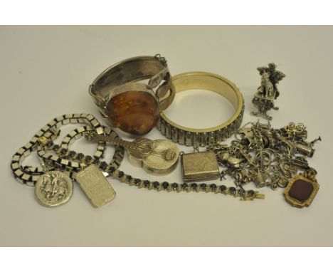 An interesting collection of jewellery comprising a bangle marked Daniel Swarovski Paris, an amber set silver bangle, various