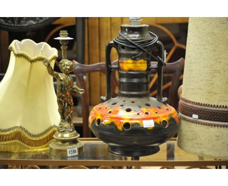A retro lava pottery lamp together with a brass lamp in the form of a cherub
