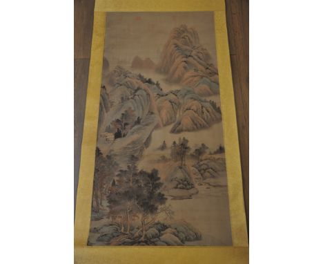 A Chinese hanging scroll decorated with landscape scenes