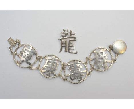 A silver bangle with Chinese character pattern and a silver pendant with Chinese character. 