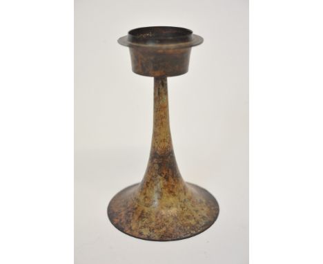 An Arts and Crafts Mottled coloured copper candlestick with circular top, narrowing support and raised circular base. 