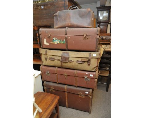 A Gladstone bag, and four large travelling trunk some still bearing remnants of original travel labels.