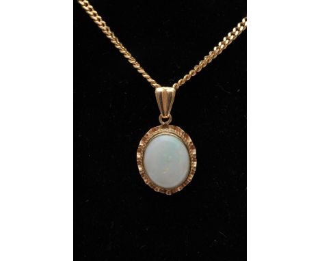 A 9ct gold mounted opal pendant on conforming gold chain