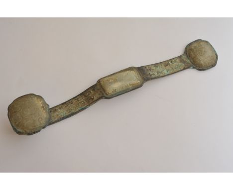 A Chinese bronze ruyi scepter of archaic form inset with three carved white stone plaques, possibly jade